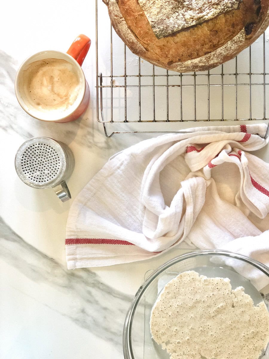 pain avec linge de table, café, farine et bol de levain